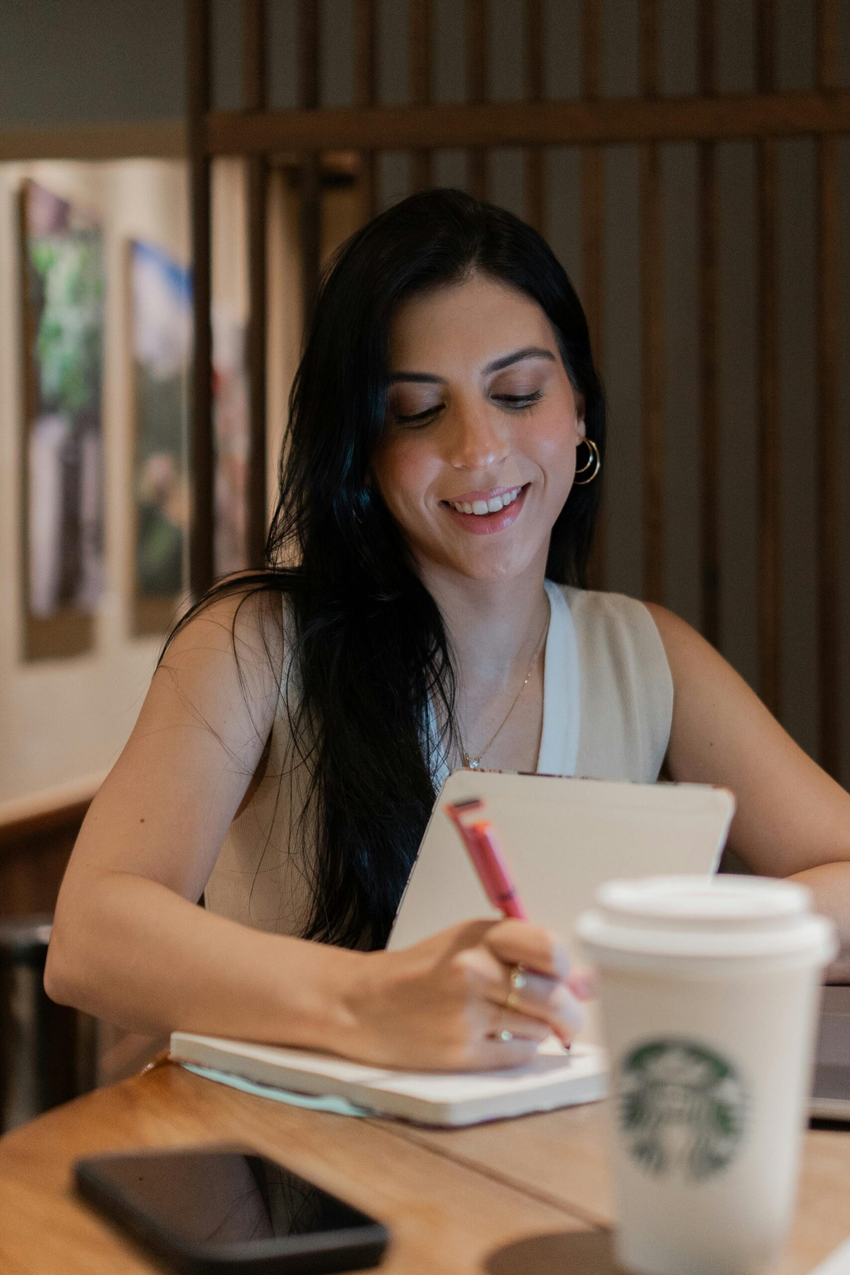 young woman writing in a notebook