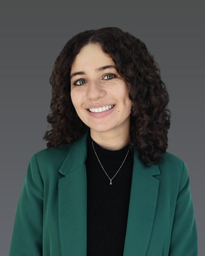 Nour K, Senior College Admissions Consultant at Admissionado, wearing a green blazer and smiling in a professional headshot