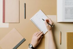 hand holding pen writing notes