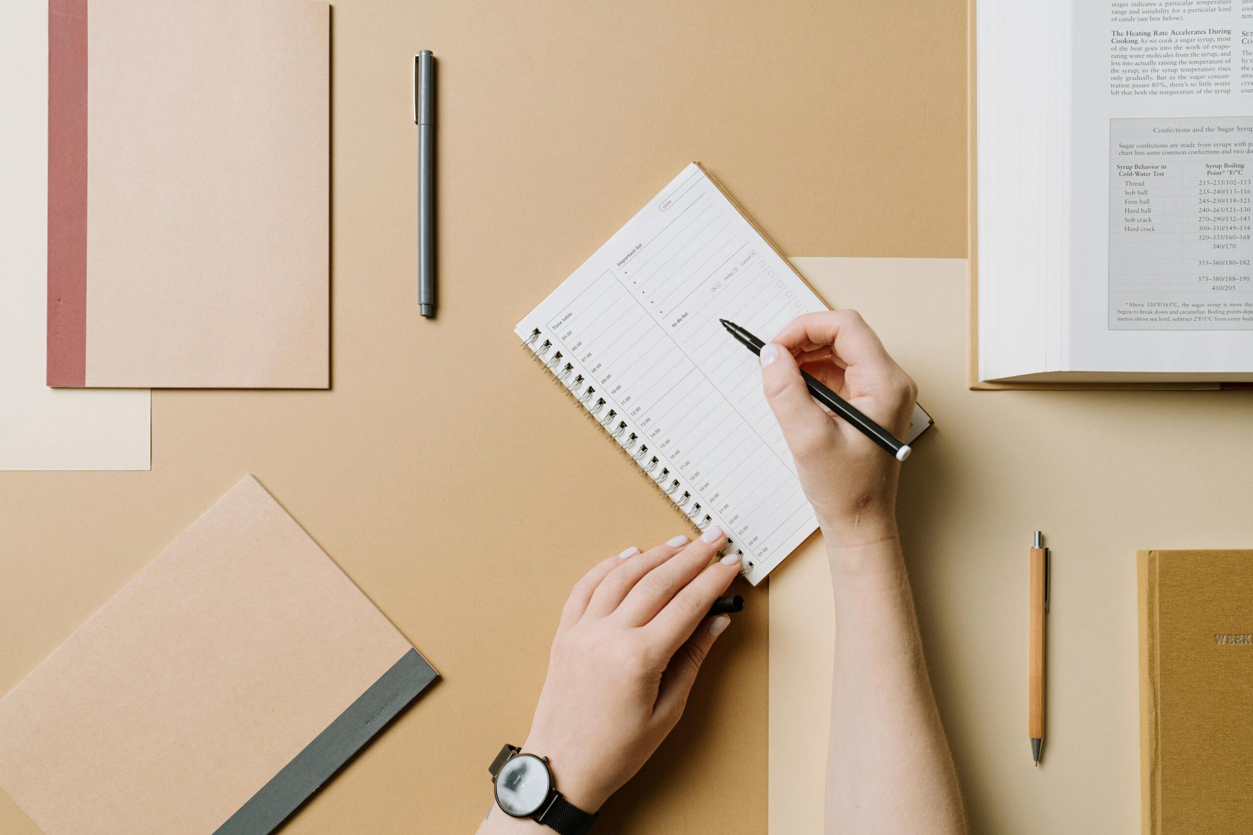 hand holding pen writing notes