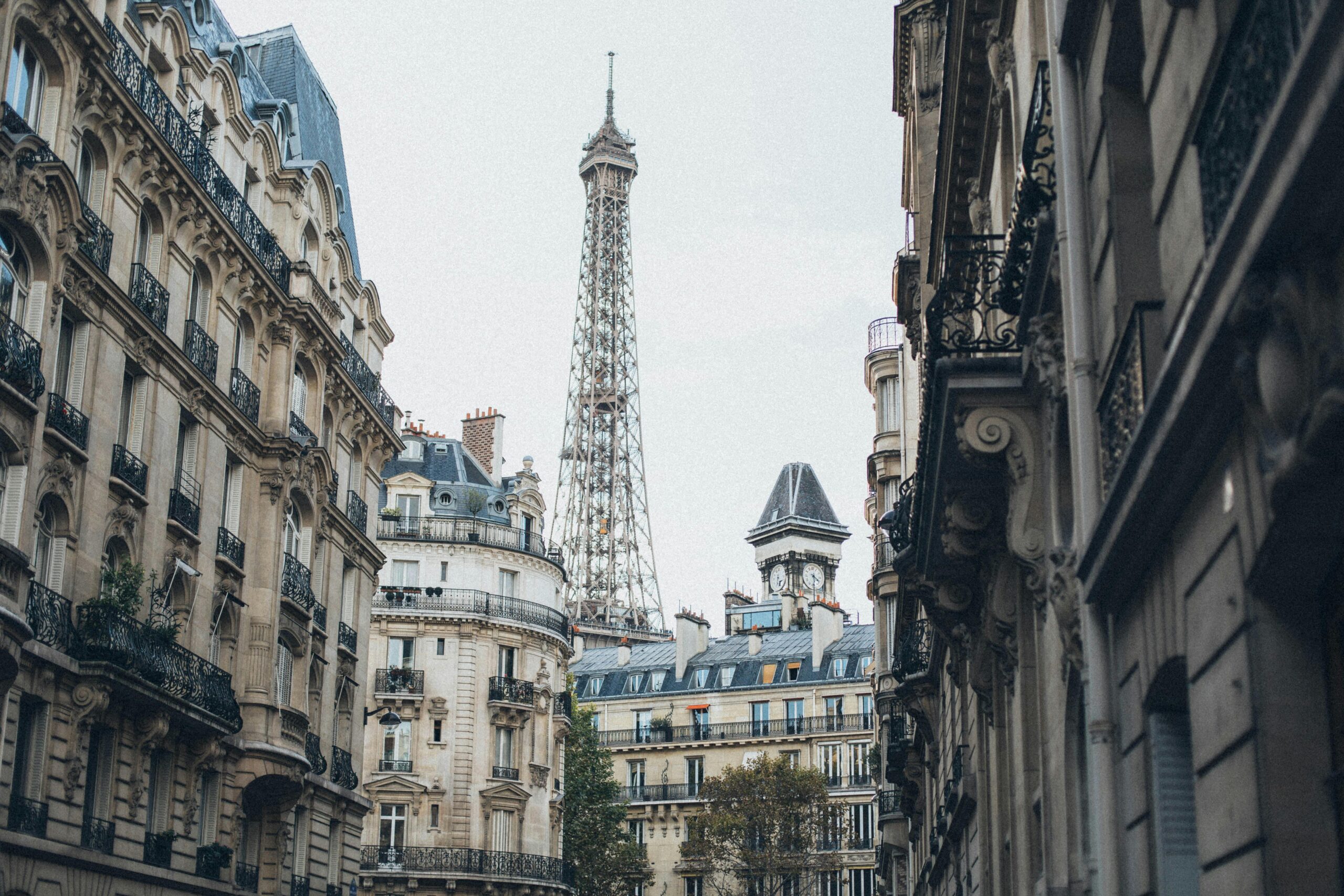 Upclose shot of european architecture on street with eiffel tower in background