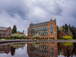 photo of university of washington building reflected in pond on a cloudy day
