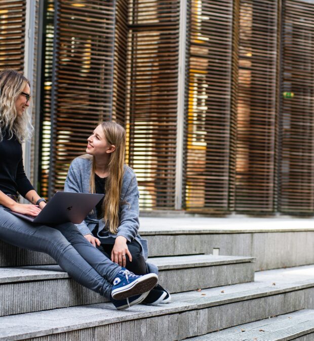 Two Women Having Conversation on Stairs