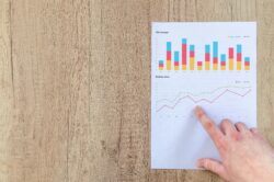 Finger pointing to graph with upward trajectory