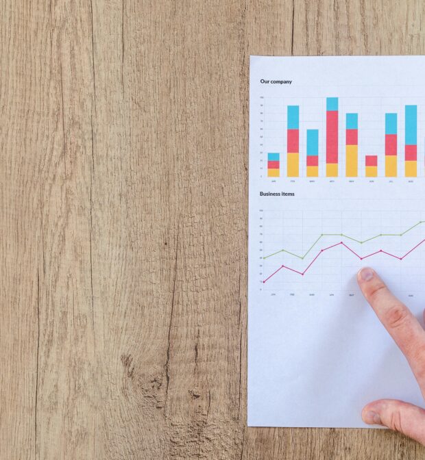 Finger pointing to graph with upward trajectory