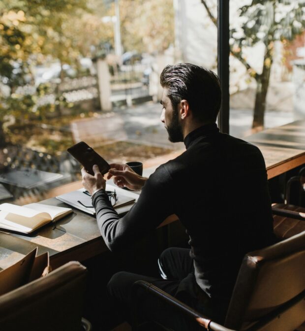 A Man Sitting while using Smartphone