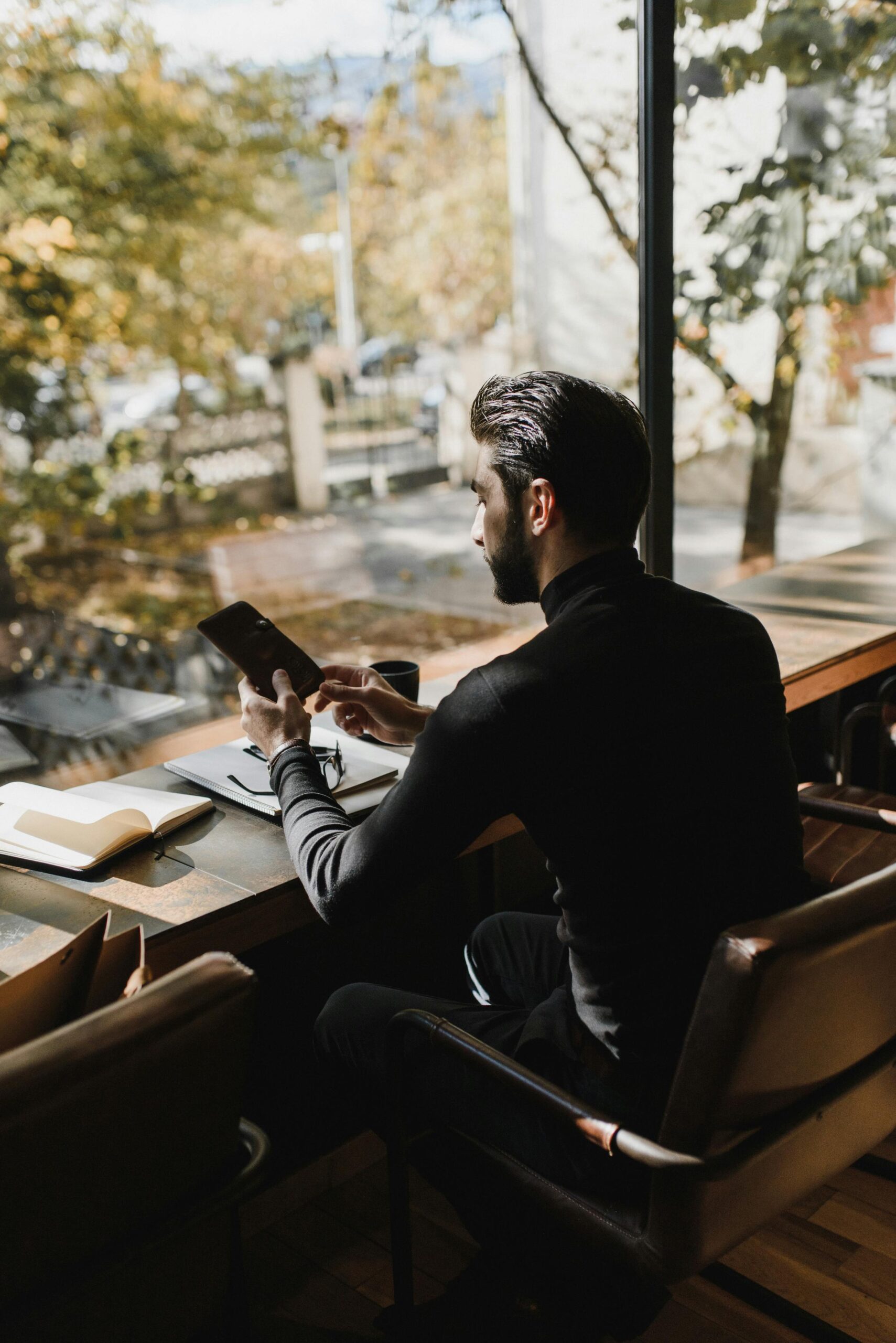 A Man Sitting while using Smartphone