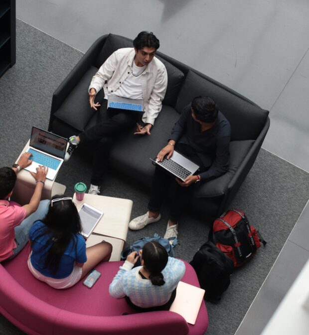 A Group of Students Sitting in a Library and Studying