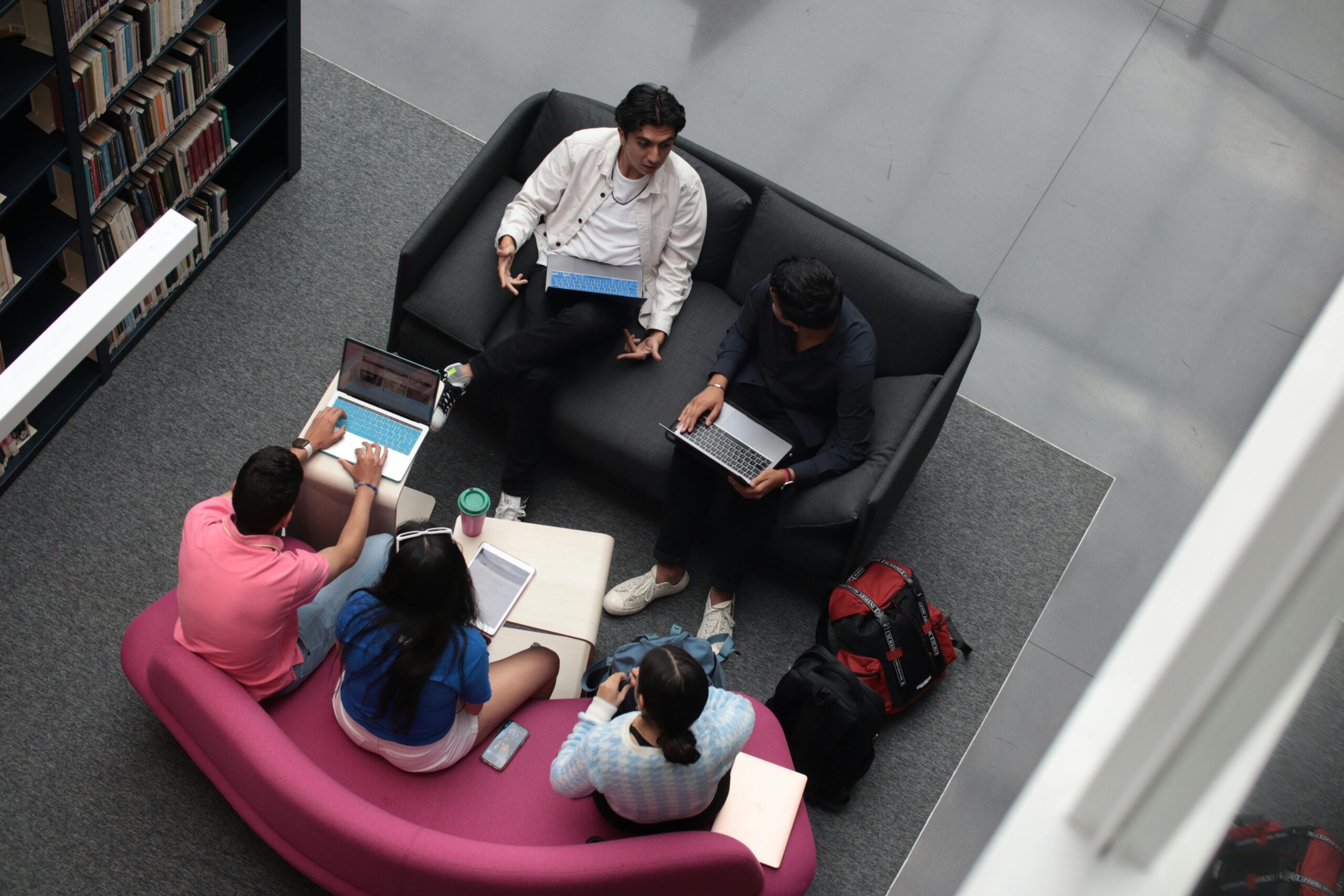 A Group of Students Sitting in a Library and Studying