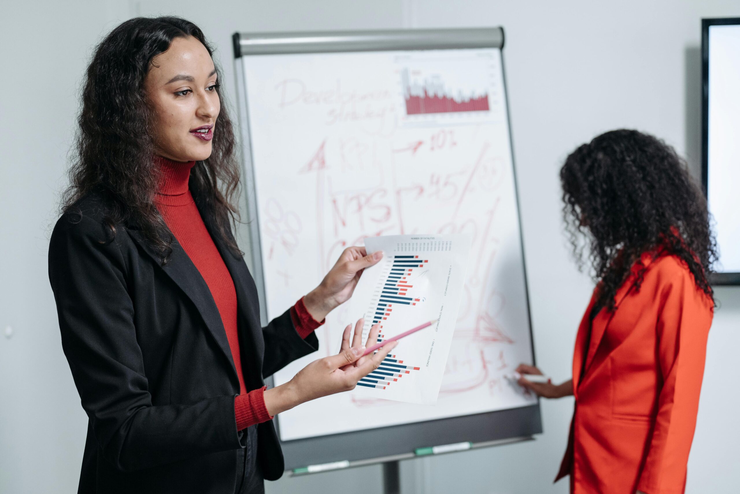 Woman in Black Blazer Discussing