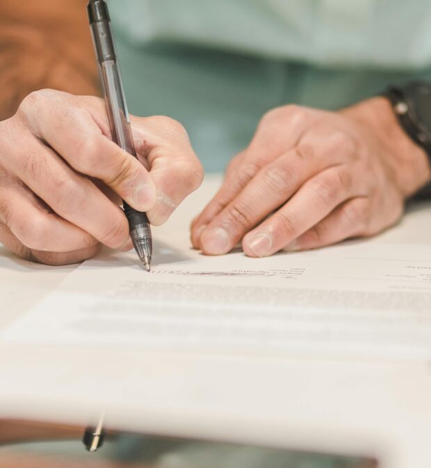 A Person Writing on White Paper