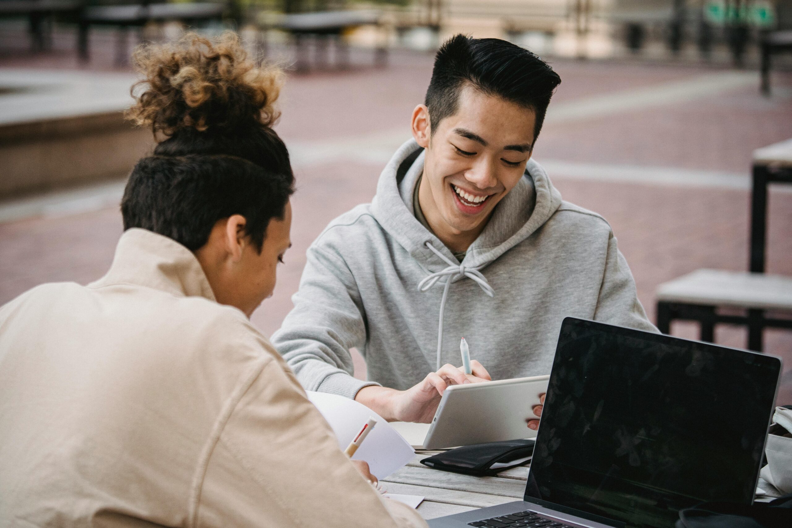 Laughing men working on assignment together