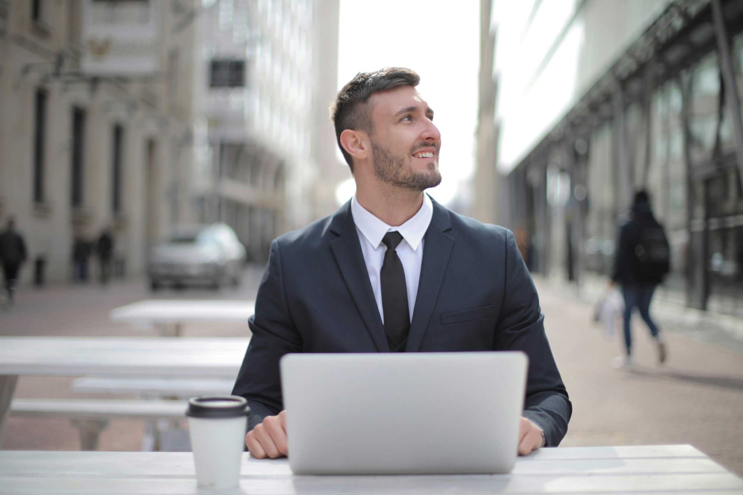 Man in Black Suit Jacket Using Macbook